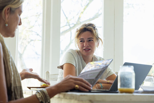 young woman working on laptop in light filled room