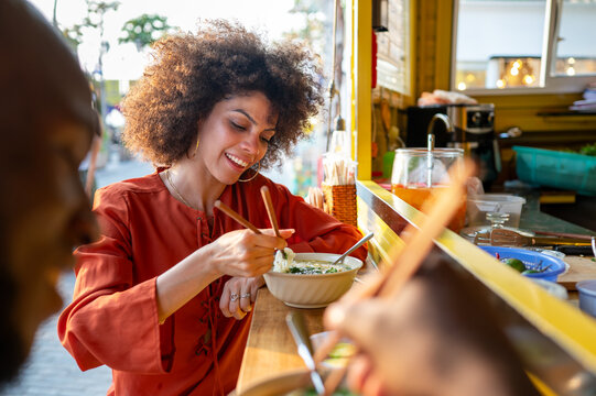 Portrait of a happy couple sharing a meal outdoors, focused on their joyful expressions, connection