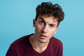 Fototapeta premium Young man showing disbelief looking at camera