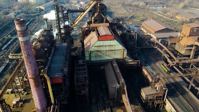 Factory, industrial enterprise, metallurgical plant, smoke from chimneys, aerial photography from a drone.