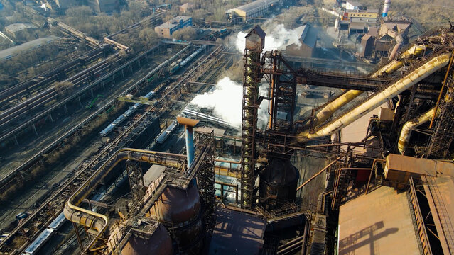 Factory, industrial enterprise, metallurgical plant, smoke from chimneys, aerial photography from a drone.