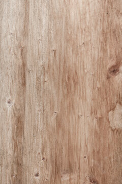 Natural light brown wood texture with visible grain and knots, perfect for backgrounds and designs.