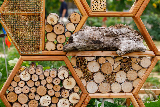 Eco-friendly bug house providing shelter for beneficial insects and pollinators in a garden.