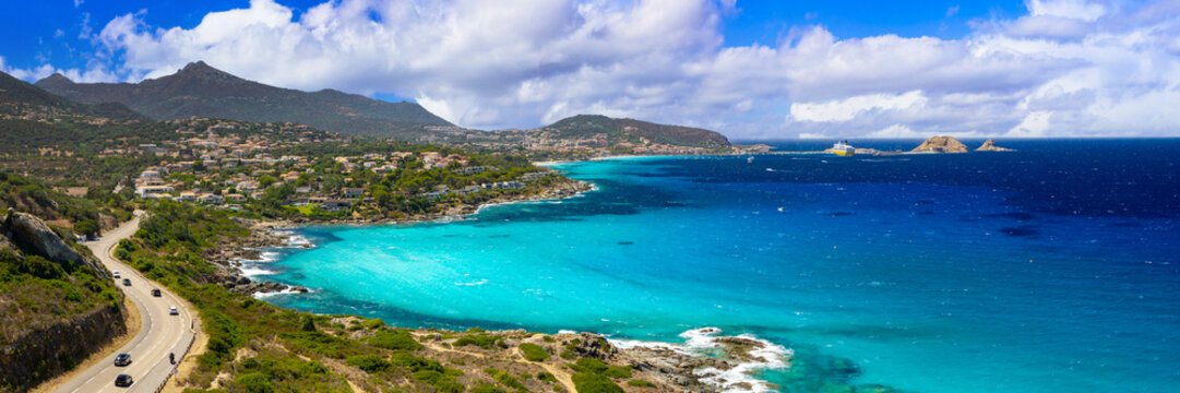 Ile Rousse Corsica 12K drone panorama photo. Winding coastal highway and sea overlooking Pietra island town and mountains. High resolution World Print fine art aerial