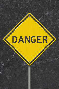 Yellow Danger warning sign with black stone for risk prevention