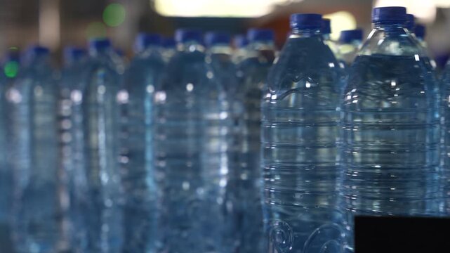 Close-Up of Bottled Water in Plastic Bottles at Factory
