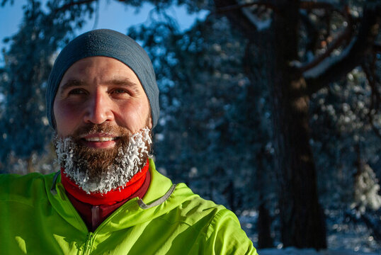Authentic winter runner portrait after a long workout in snowy nature