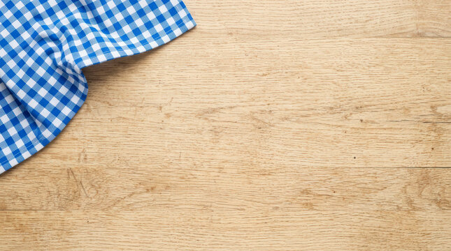 Checkered napkin on wooden table top view, food presentation and culinary preparation