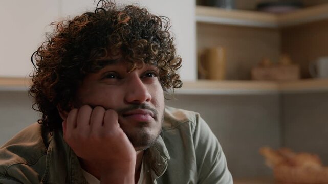 Close up worried Indian man thinking about problem at home kitchen Arabian male freelancer bored sad ethnic businessman searching solution remembering idea deep thoughts pondering planning decision