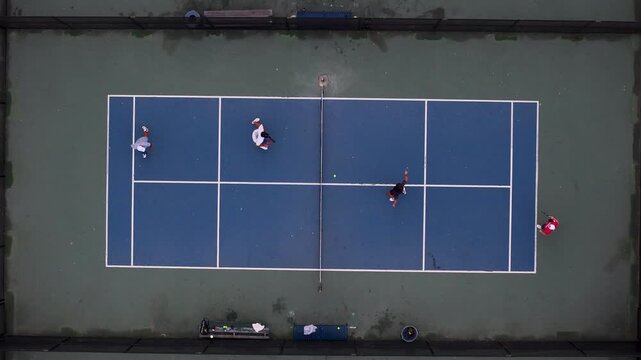Los Angeles, California, United States - 03 September 2026: Aerial view of people playing pickleball on a court at Venice Beach with players moving across the blue surface.