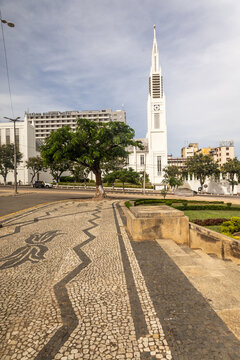 Traditional patterned Portuguese cobblestone pavement, leading towards the white Art Deco Maputo Cathedral, at Independence Square in Maputo City, Mozambique