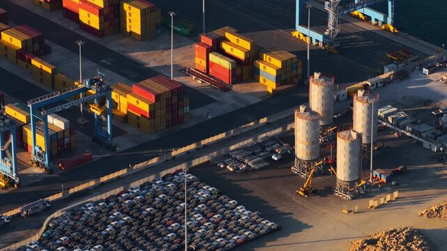 Civitavecchia, Lazio, Italy - 23 August 2026: Aerial view of Civitavecchia Port with shipping containers, parked cars, and industrial silos at the harbor.