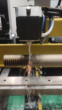 Electric Discharge Machining. Wire-cut electrical discharge machining EDM on CNC machine. Machine cutting metal, wire containing electrical discharges in dielectric. High-precision process Vertical