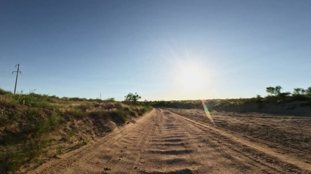 Driving forward on a dirt road in an arid landscape