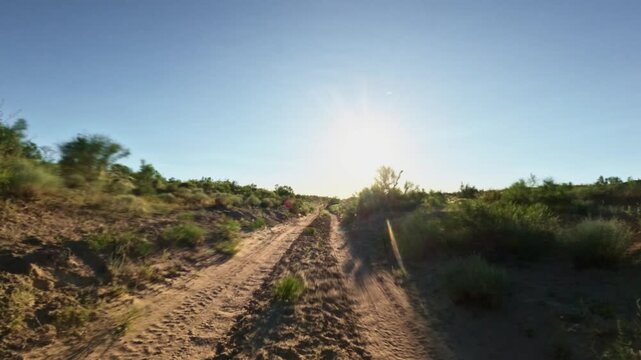 Forward movement along a dirt road in a dry landscape