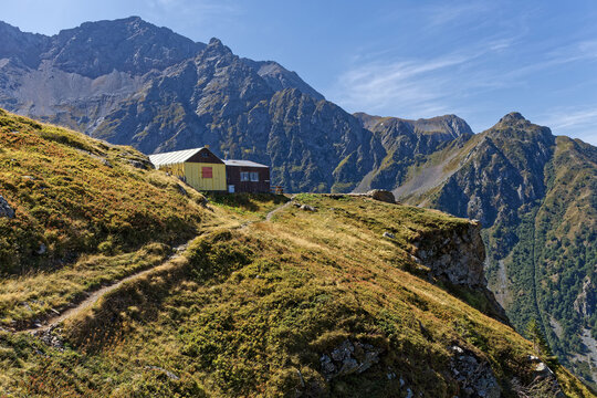 Mountain path arrives at the Refuge Jean Collet in Belledonne range
