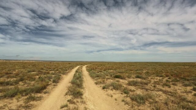 Forward movement along an arid dirt road in a plain