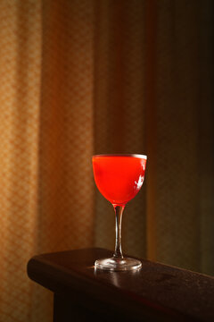 Red Alcoholic Sour Cocktail with Foam in Stemmed Glass Close Up