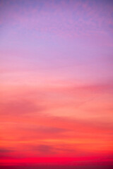Obraz premium Sky sunset,Beautiful sunrise sky with vibrant gradient orange and gold colors and soft blue, Clear atmosphere with wispy clouds. Peaceful, perfect for background and copy space, vertical