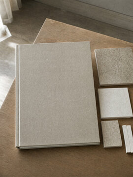Tile sample binder cover mockup with ceramic tiles on an oak table