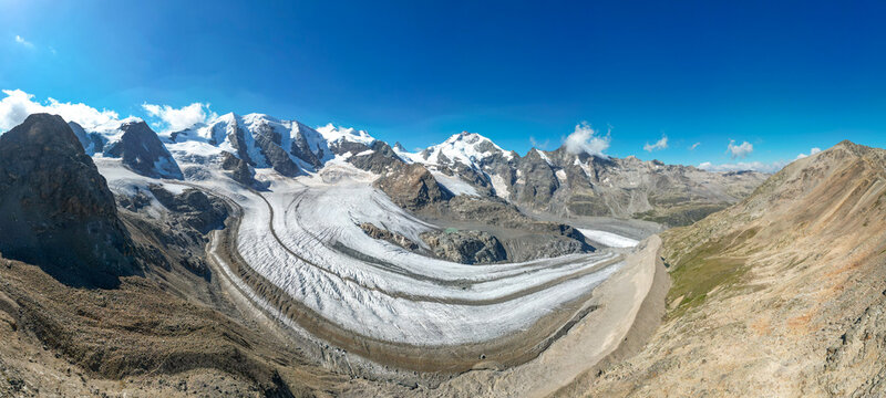 Aerial view of Pers Glacier with Piz Bernina and Piz Palu surrounded by snow-capped mountain peaks and rocky terrain in Pontresina, Grisons, Switzerland.