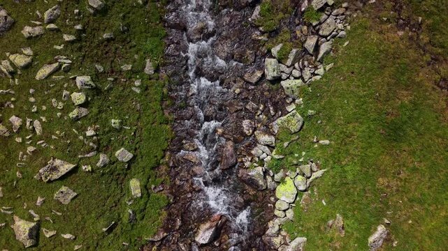 Aerial view of mountain stream flowing over rocks