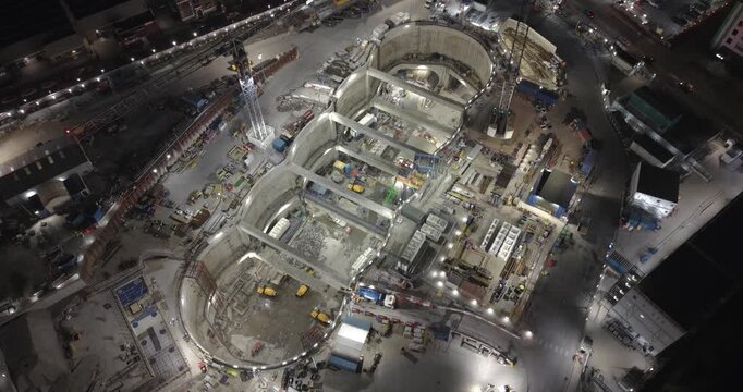 London, United Kingdom - 21 March 2026: Aerial view of the HS2 Victoria Road Crossover Box construction site at night with illuminated excavation and heavy machinery.