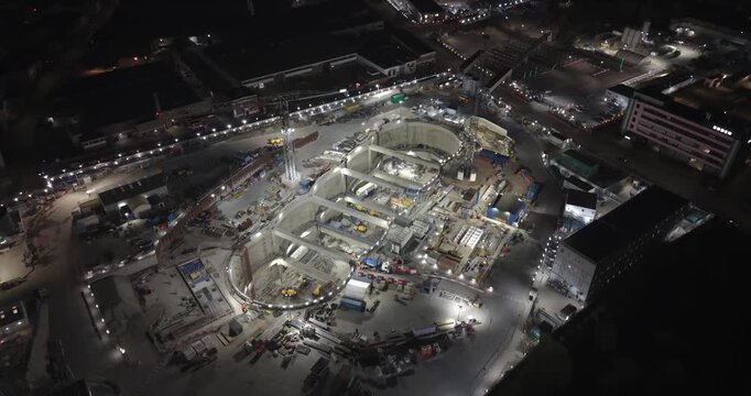 London, United Kingdom - 21 March 2026: Aerial view of the HS2 Victoria Road Crossover Box construction site at night with illuminated cranes and deep excavation pits.