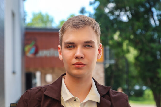 Close-up portrait of handsome fair-haired young man aged 18-20, blond hair, male face, lifestyle photography.
