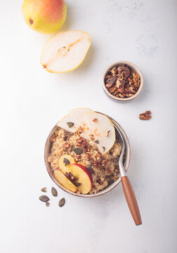 Fall autumn breakfast oats pear apple nuts seeds top view