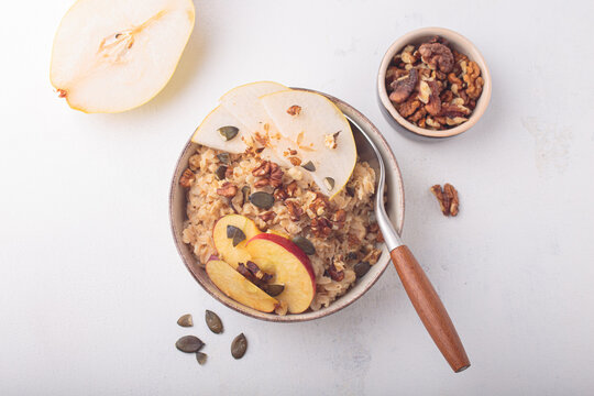 Fall autumn breakfast oats pear apple nuts seeds top view