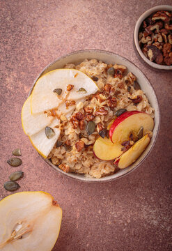 Autumn oats porridge bowl apple pear walnuts top view healthy fiber