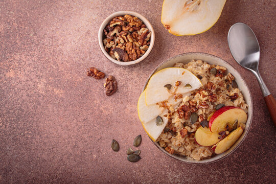 Autumn oats porridge bowl apple pear walnuts top view healthy fiber ccopy space