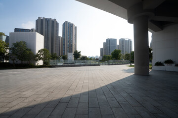 Obraz premium Modern city architecture square open landscape with tall buildings and shadows