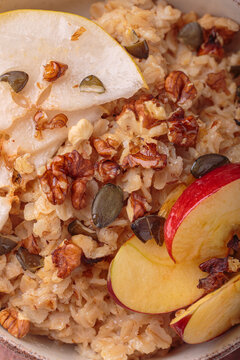 Close up macro oatmeal pear apple slices walnuts texture