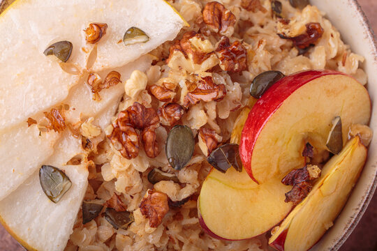 Close up macro oatmeal pear apple slices walnuts texture
