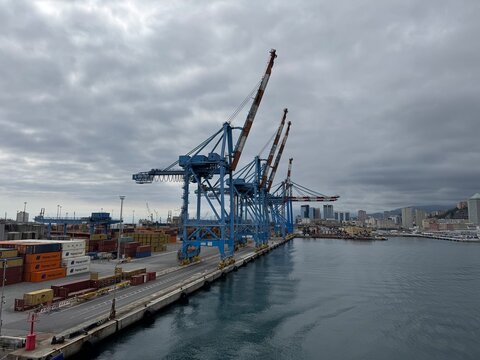 26 April 2026, Italy, Liguria, Genoa, Port Terminal Contenitori - MSC and Hapag-Lloy container next to seaport gantry PSA SECH STS cranes semi-circular beam for unloading and loading infrastructure