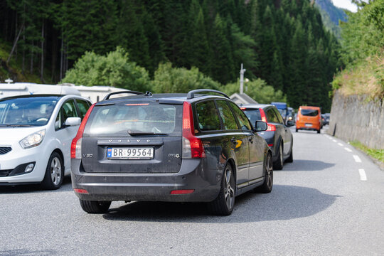 August 16, 2026, Skare, Norway - Traffic jam with a dark grey Volvo V50 station wagon on a mountain road