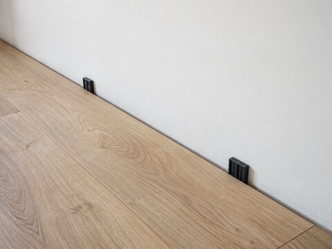SPC Flooring Expansion Gap with Spacers Along a Wall