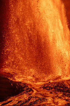 View of Kilauea Crater erupting with a powerful fountain of molten lava and glowing volcanic rock fragments in Hawaii County, Hawaii, United States.