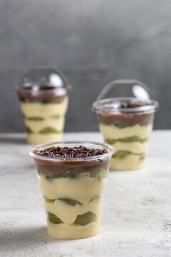 Layered Brazilian Grape and Chocolate Dessert Cups on Light Background
