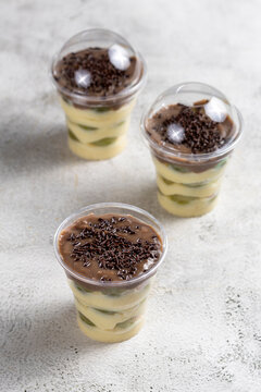 Layered Brazilian Grape and Chocolate Dessert Cups on Light Background