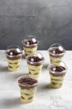 Layered Brazilian Grape and Chocolate Dessert Cups on Light Background