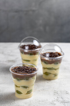Layered Brazilian Grape and Chocolate Dessert Cups on Light Background