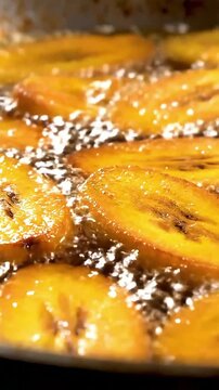 Slices of Sweet Ripe Plantains Frying in Hot Bubbling Oil, a Traditional and Tasty African Food