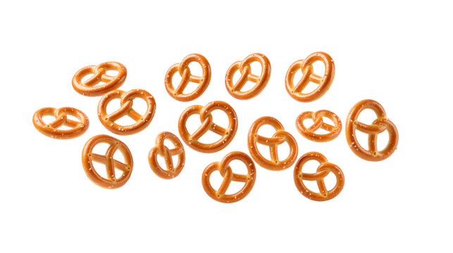 Salted mini pretzels falling in mid air, isolated on transparent background