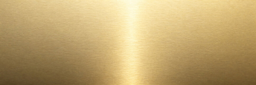 Brushed gold metal texture with light reflection. Elegant metallic brass background. Polished golden surface for luxury design.