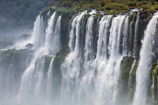 View of Iguazu Falls with cascading water and lush green vegetation in Iguazu National Park, Puerto Iguazu, Misiones, Argentina.