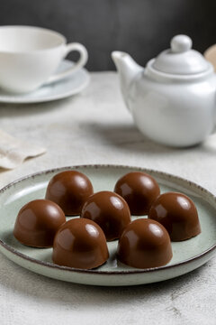 Gourmet Milk Chocolate Bonbons and Chocolate Truffles on Ceramic Plate