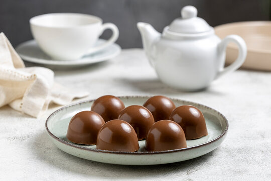 Gourmet Milk Chocolate Bonbons and Chocolate Truffles on Ceramic Plate